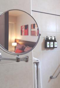 a bathroom with a mirror on the wall at Palermo Suites Buenos Aires Apartments in Buenos Aires