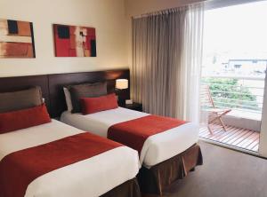 Ένα ή περισσότερα κρεβάτια σε δωμάτιο στο Palermo Suites Buenos Aires Apartments