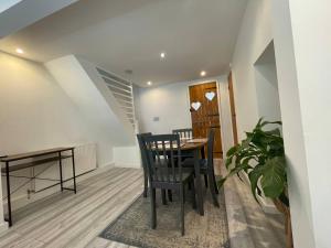 a dining room with a table and chairs and a plant at Tucked away house in Macclesfield in Macclesfield +6 photos