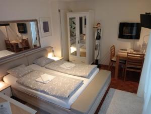 a bedroom with two beds and a mirror at Sonnenstrahl in Locarno