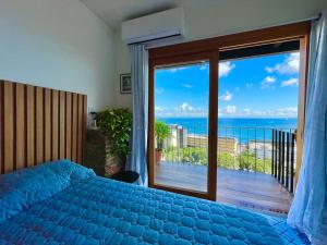a bedroom with a bed and a view of the ocean at Studio da fonte/Vista mar in Salvador