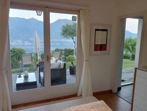 a living room with a sliding glass door to a patio at Sonnenstrahl in Locarno
