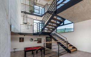 a spiral staircase in a loft with a red table at Complex Barbara in Vižinada