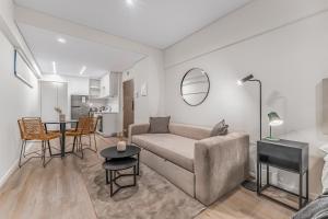 a living room with a couch and a table at La Vie Suite Cañitas in Buenos Aires