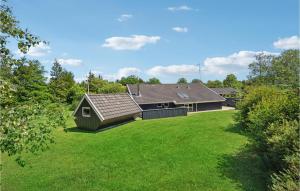 a house with a green lawn in front of it at 5 Bedroom Lovely Home In Oksbøl in Oksbøl +15 photos