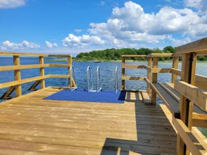 a wooden dock with a yoga mat on the water at Stuga i Borgholms villa in Borgholm