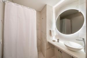 a white bathroom with a sink and a mirror at La Vie Suite Cañitas in Buenos Aires +44 photos