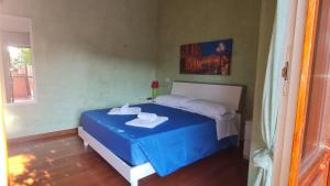 a bedroom with a bed with a blue table in it at Residenza Fiera Verona in in Verona