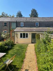 a house with a garden in front of it at Relaxing cottage in the beautiful Usk Valley in Usk