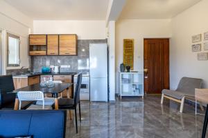 a kitchen with a table and a refrigerator at Engomi Apartment in Yukarı Lakatamya