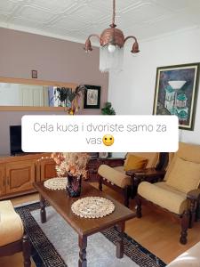 a living room with a coffee table and chairs at Dusica in Vrnjačka Banja