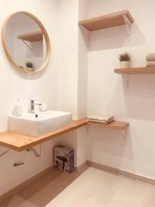 a bathroom with a sink and a mirror at Serafina suite byArtistUnknown in Vari