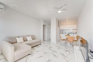 a living room with a couch and a table at Prime apartments Club Paraiso Ocean view in Playa Paraiso