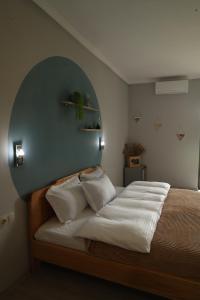 a bedroom with a large bed with an arch above it at hOlarooms N2 in Tʼianetʼi