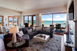 a living room with a couch and a table at Sugar Beach Villa 1012 Luxury Waterfront Condo in Traverse City