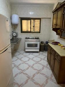 a kitchen with a stove and a tiled floor at قرية جرين بيتش in El Alamein
