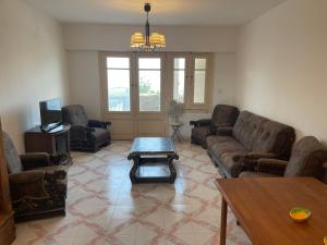 a living room with couches and a coffee table at قرية جرين بيتش in El Alamein