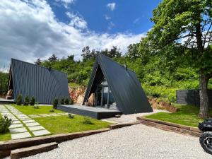 a modern house with a black roof at Loon Moon Mountain Chalets in Sarajevo