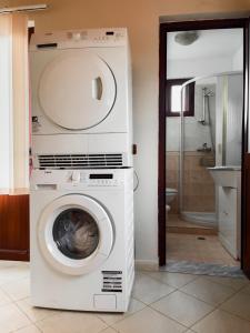 a washer and dryer in a bathroom at Vila Kodra in Tirana