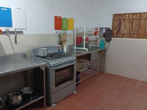 a kitchen with a stove and a counter top at Alojamiento Ya'ax Nah in Playa del Carmen