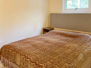 - un lit dans une chambre avec fenêtre dans l'établissement Holiday home Huaröd, à Huaröd