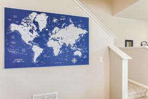 a blue map of the world on a wall at Brand New Townhome with King Suite Near DIA in Denver