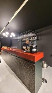 a bar with a red counter with food on it at ZUPPOLINI Apart Hotel in Bananeiras
