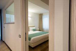 Postel nebo postele na pokoji v ubytování Hotel Ponti