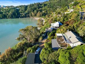 uma vista aérea de uma casa numa colina ao lado de um lago em Kaioruru View - Diamond Harbour Holiday Home em Diamond Harbour