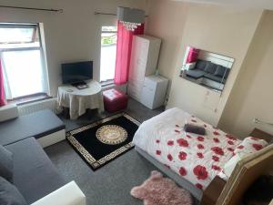 a small room with a bed and a couch at Quite Broad Rest 3 in Longford