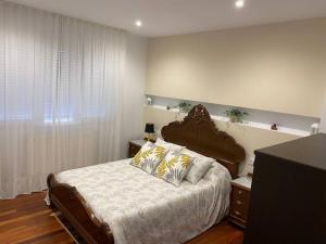 a bedroom with a large bed and a window at Casa de María in Muros