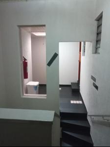 a hallway with stairs and a toilet in a building at Hotel Malibu (ADULT ONLY) in São Paulo