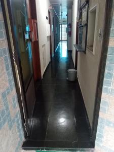 a hallway in a hospital with a tile floor at Hotel Malibu (ADULT ONLY) in Sao Paulo