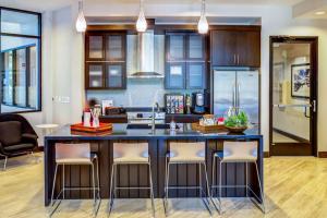 a kitchen with a large black island with bar stools at Barton Springs 1br w wd gym pool nr Town Lake ATX-189 in Austin