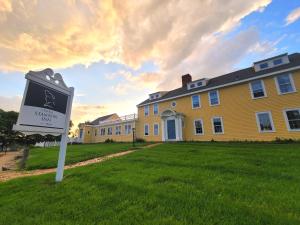 a yellow house with a sign in front of it at The Historic General Stanton Inn in Charlestown