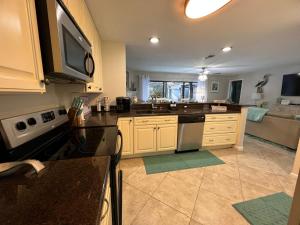 a kitchen with a sink and a stove top oven at TPC Sawgrass Coastal Retreat in Ponte Vedra Beach