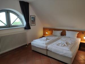 a bedroom with a bed and a large window at Ferienhaus Waterkant in Dewichow