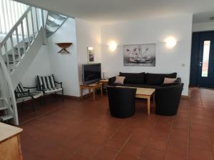 a living room with a couch and a tv at Ferienhaus Waterkant in Dewichow