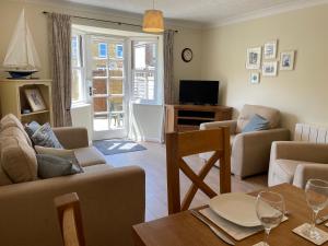 a living room with a couch and a table at Courtyard House, with parking and patio garden in Whitstable