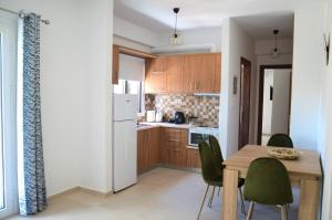 a kitchen and dining room with a table and chairs at Α & D Perikleous Apartments in Kyllini