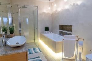 uma casa de banho com um chuveiro, um lavatório e uma banheira em Apartament Termalny DELUX em Uniejow