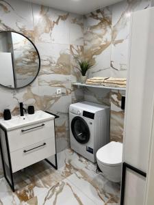 a bathroom with a washing machine and a washer and dryer at AV apartamentai Palangoje in Palanga +20 photos