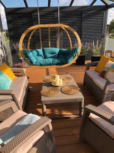 a patio with couches and chairs and a swing at Apartament Termalny DELUX in Uniejow