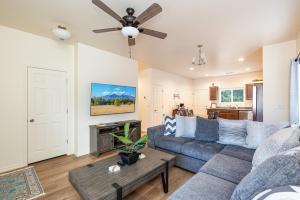 a living room with a couch and a ceiling fan at Mt. Elden Adventure in Flagstaff