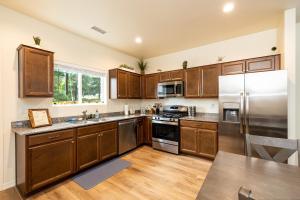a kitchen with wooden cabinets and stainless steel appliances at Mt. Elden Adventure in Flagstaff