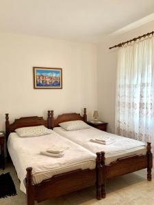 a bedroom with a large bed with white sheets at Talija Apartments in Bijela +10 photos