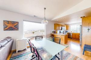 a kitchen and living room with a table and a couch at JS Beach House in Lincoln City