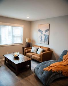 a living room with a couch and a coffee table at 1 Bedroom Stylish Oasis in Omaha