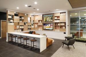 a living room with a bar with stools at Downtown Bellevue 2BR w WD Rooftop nr all SEA-141 in Bellevue