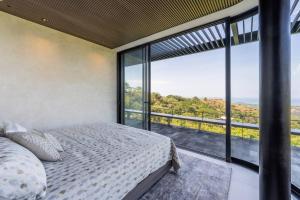 1 dormitorio con cama y ventana grande en Casa Gaia - New Oceanview Luxury Mansion, en Santa Marta